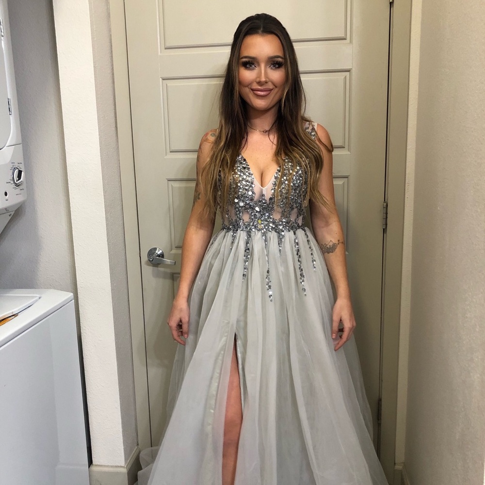 Silver jeweled evening gown with tulle skirt and deep slit